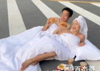 男女裹床单躺斑马线拍婚纱照 做这么危险的动作当时没有人制止吗？